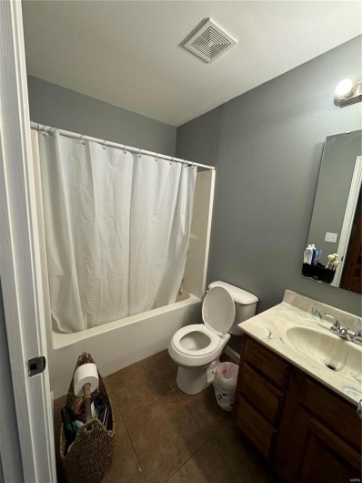Bedroom 3 Full bathroom featuring shower / tub combo, vanity, a textured ceiling, tile patterned flooring, and toilet