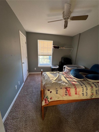 Bedroom 1 with carpet flooring and ceiling fan