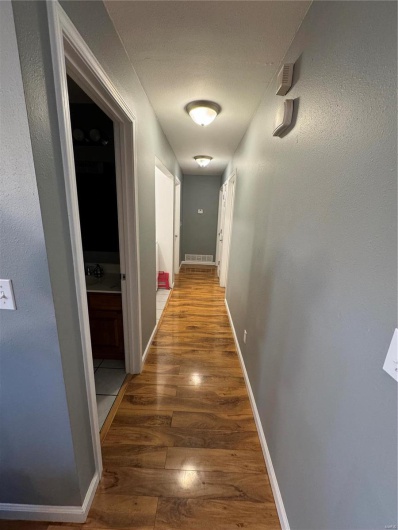 Hallway featuring wood-type flooring