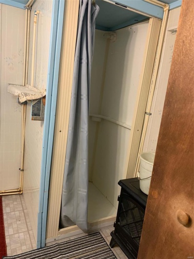 Bathroom with tile patterned floors and walk in shower
