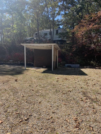 View of outbuilding with a lawn