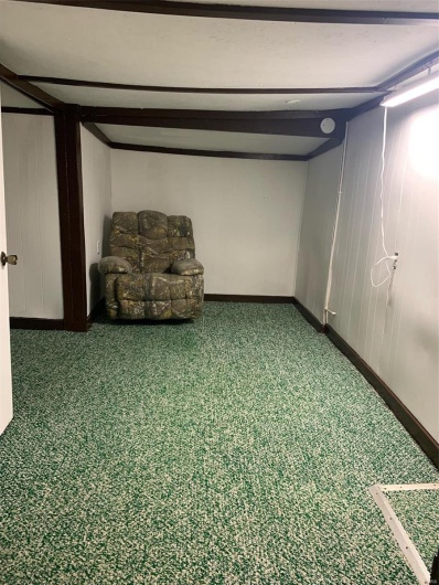 Unfurnished room featuring beam ceiling and carpet