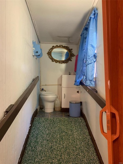 Bathroom with toilet and tile patterned floors