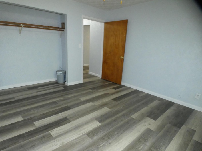 Unfurnished bedroom with a closet and dark hardwood / wood-style floors