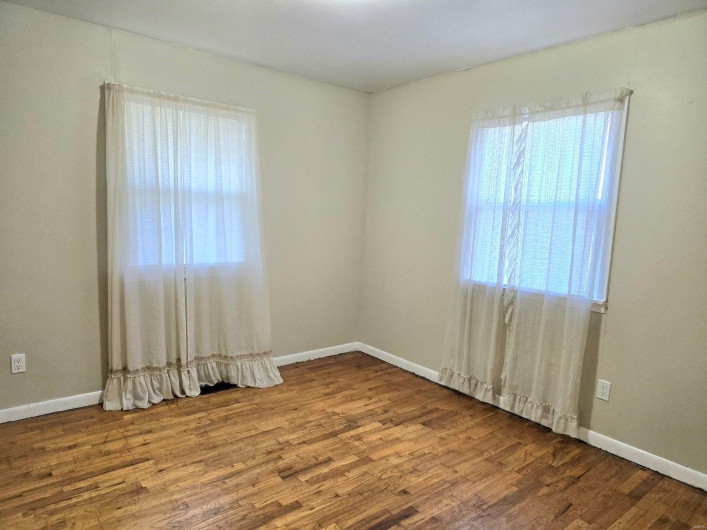 Unfurnished room featuring hardwood / wood-style flooring
