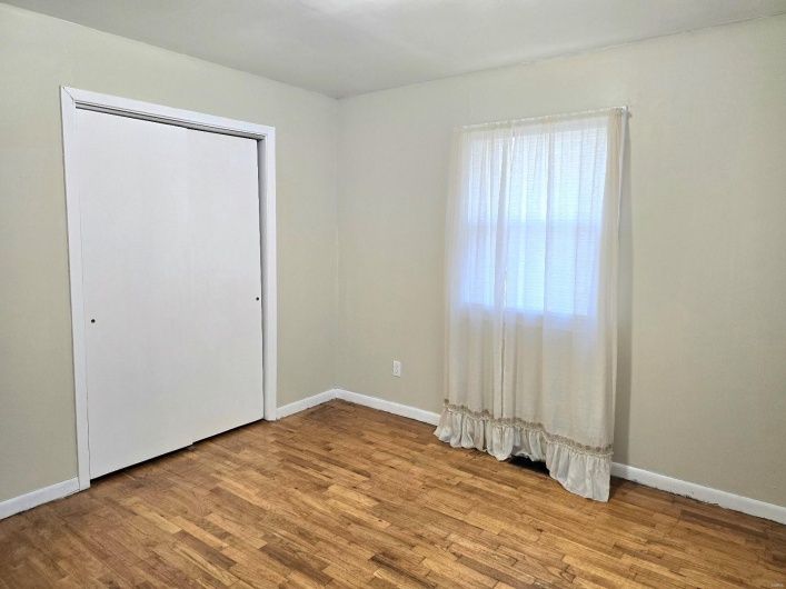 Unfurnished bedroom featuring a closet and light wood-type flooring