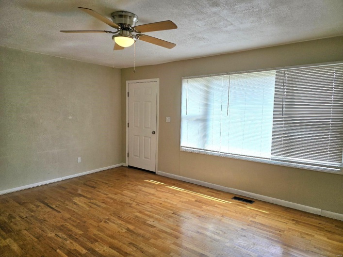 Spare room with a textured ceiling, light hardwood / wood-style floors, and ceiling fan