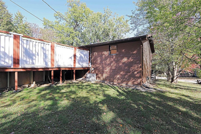 Back of property with a yard