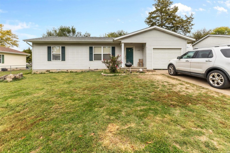 Single story home featuring a front lawn and a garage