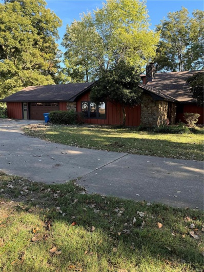 View of side of property featuring a yard and a garage
