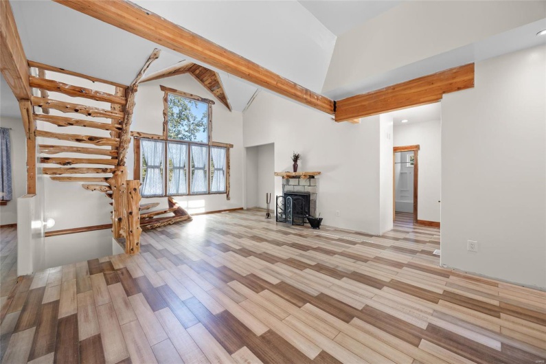 Living room featuring vaulted beamed ceiling