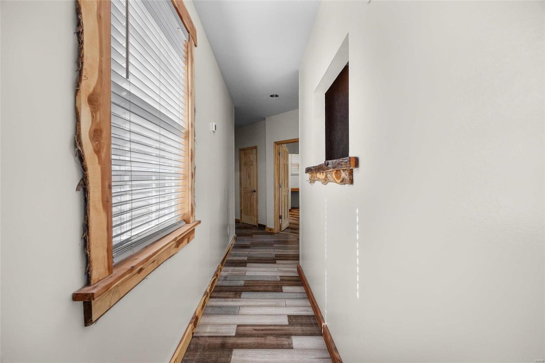 Hallway to primary bedroom/garage/and laundry 