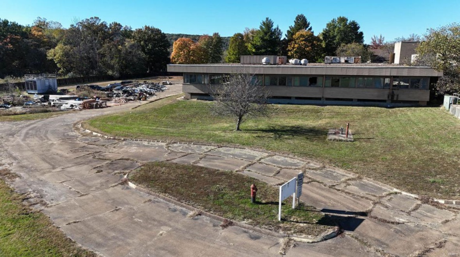 Rear view of house featuring a yard