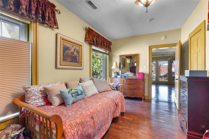 Bedroom with dark hardwood / wood-style floors