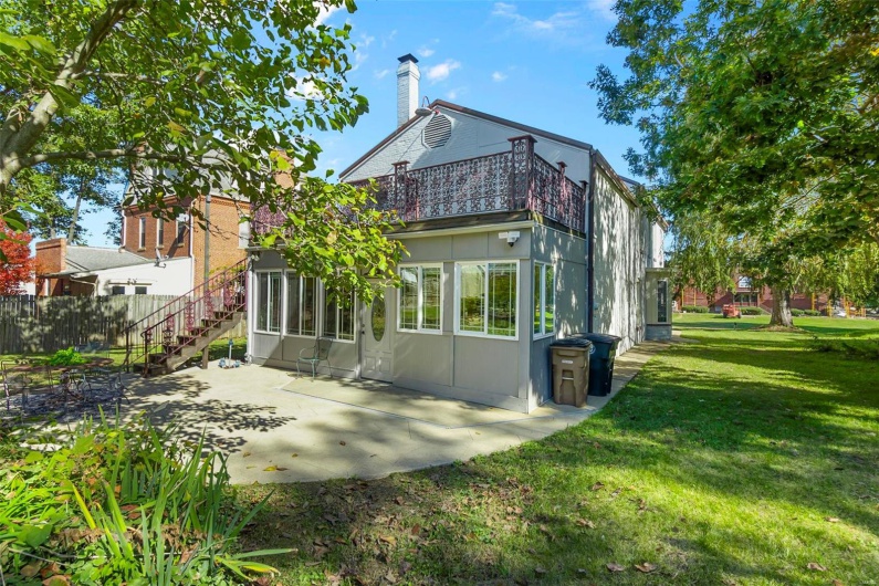 Rear view of property with a patio area and a yard