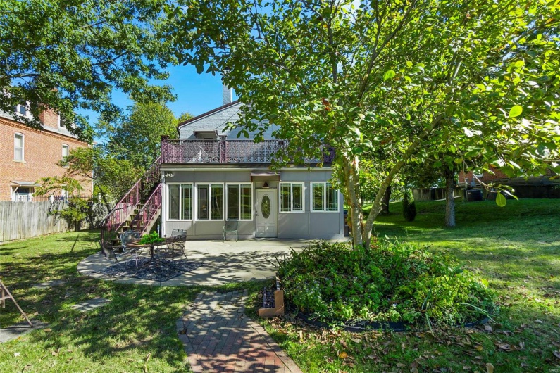 Back of property featuring a patio and a yard