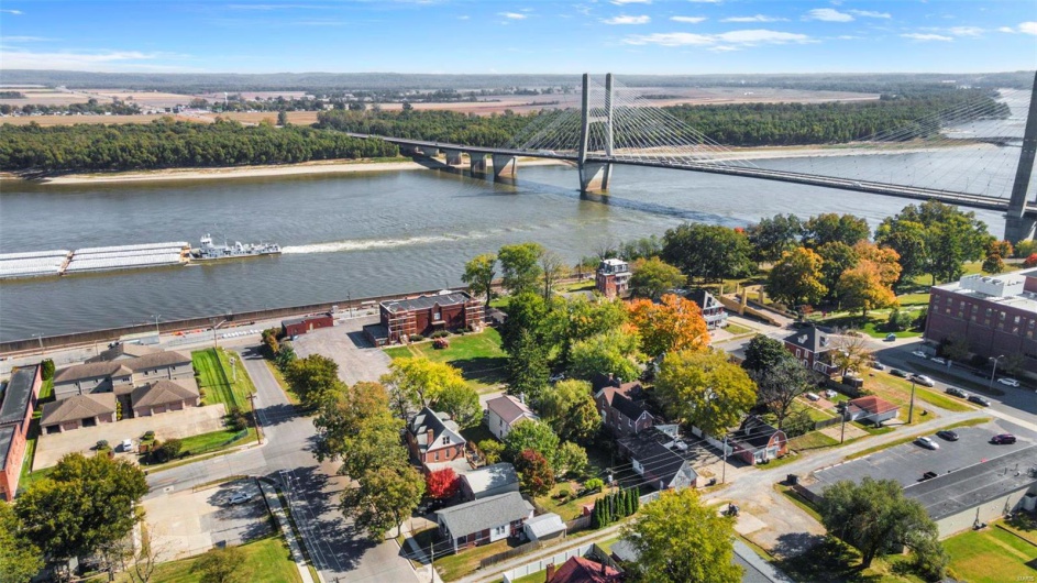 Birds eye view of property with a water view