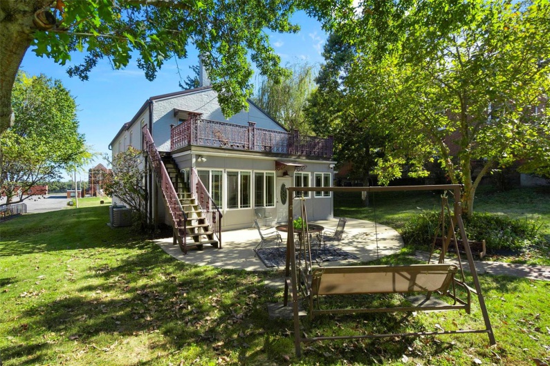 Back of property with a patio, a yard, and central air condition unit