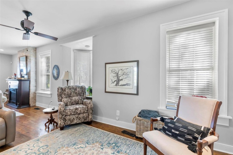 Sitting room with hardwood / wood-style floors and ceiling fan