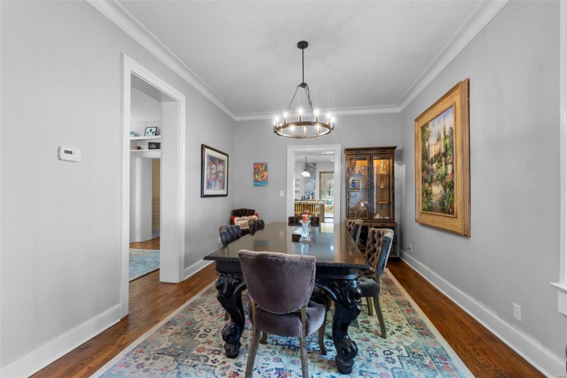 Dining area featuring crown molding, a chandelier, and dark hardwood / wood-style flooring