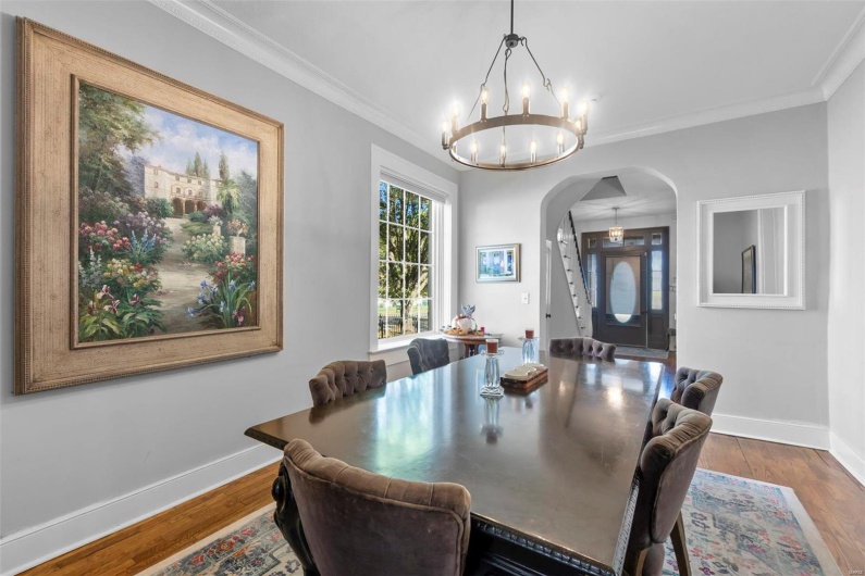 Dining area featuring ornamental molding and hardwood / wood-style flooring