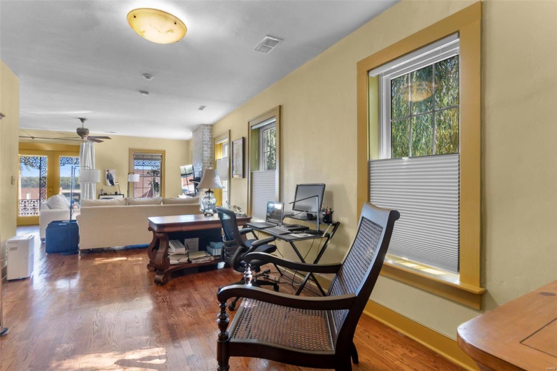 Office space with hardwood / wood-style floors and ceiling fan