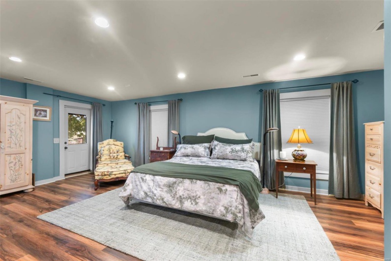 Bedroom with dark hardwood / wood-style floors