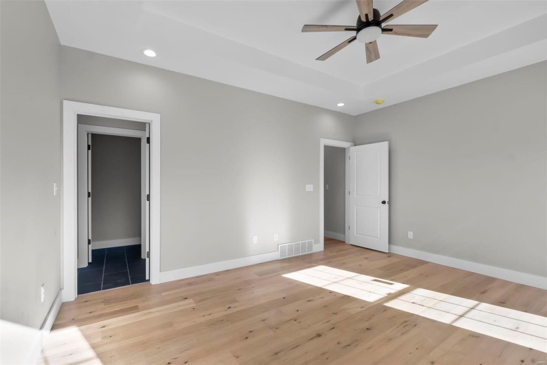 Unfurnished bedroom featuring ceiling fan and light hardwood / wood-style flooring