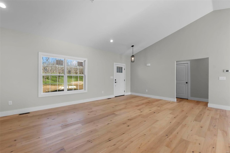 Interior space featuring light hardwood / wood-style flooring and lofted ceiling