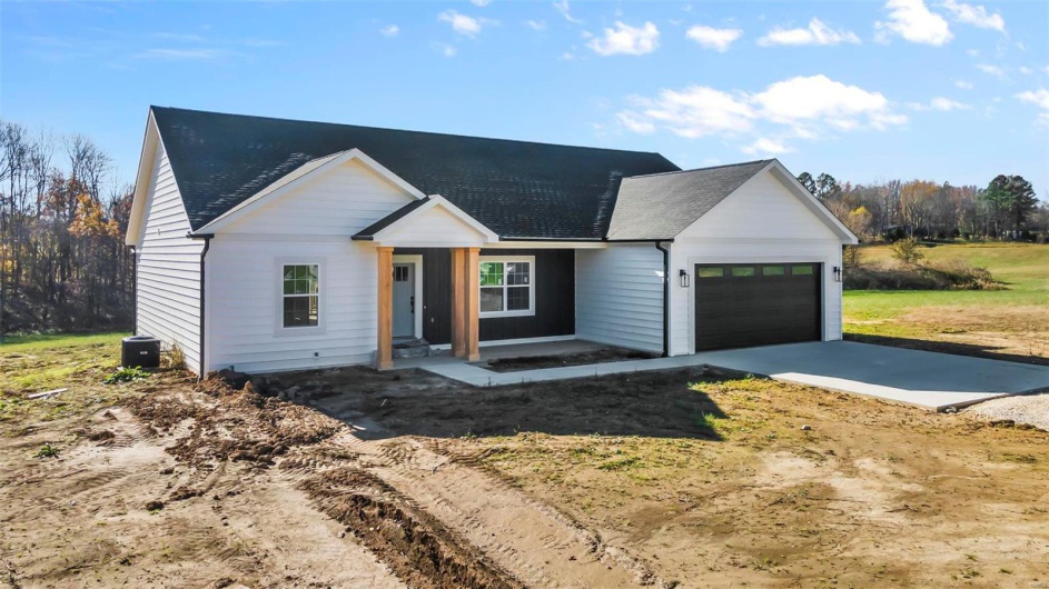 Modern inspired farmhouse featuring central AC unit and a garage