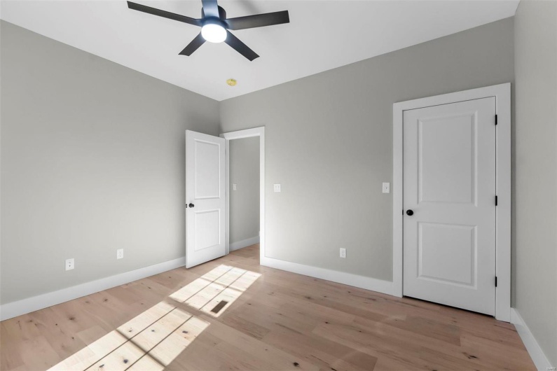 Unfurnished bedroom featuring light hardwood / wood-style floors and ceiling fan