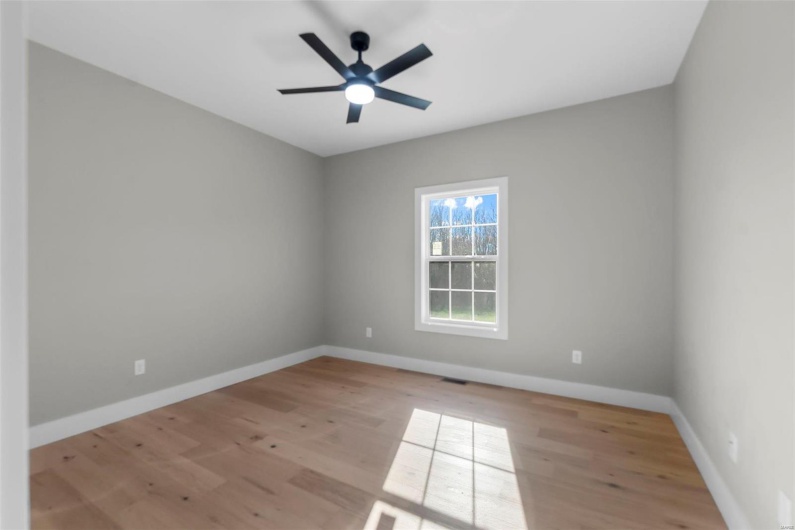Unfurnished room featuring ceiling fan and light hardwood / wood-style flooring