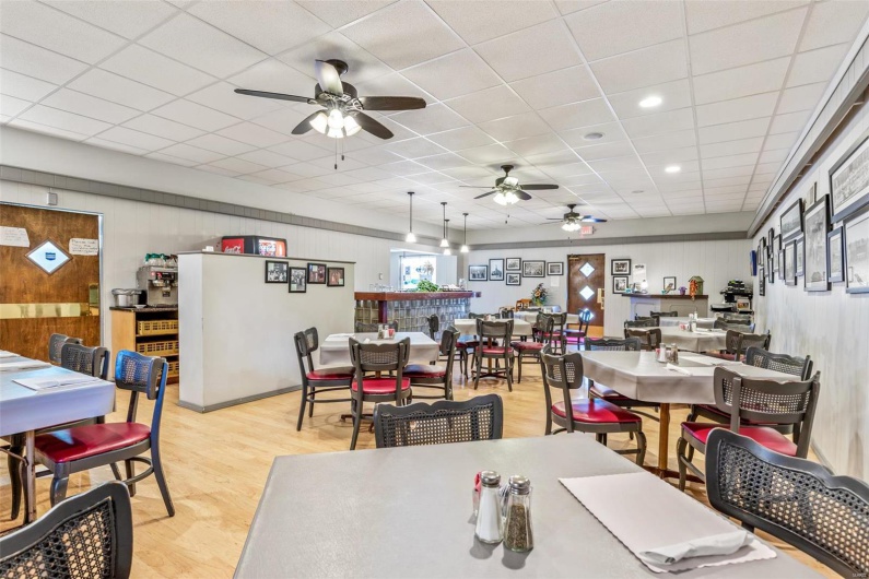 Dining area with a drop ceiling and light wood-type flooring