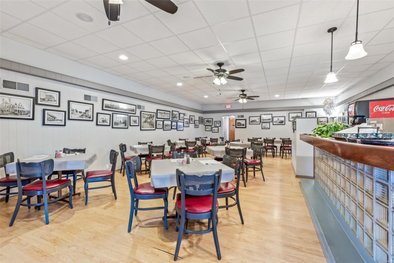Dining room featuring a paneled ceiling, light hardwood / wood-style flooring, and ceiling fan