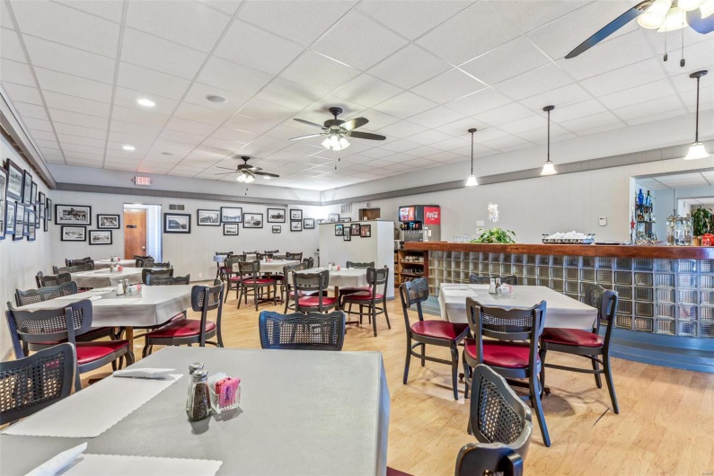 Dining room with a paneled ceiling, light wood-type flooring, and ceiling fan