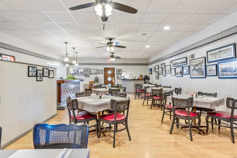 Dining area featuring a paneled ceiling, light wood-type flooring, and ceiling fan