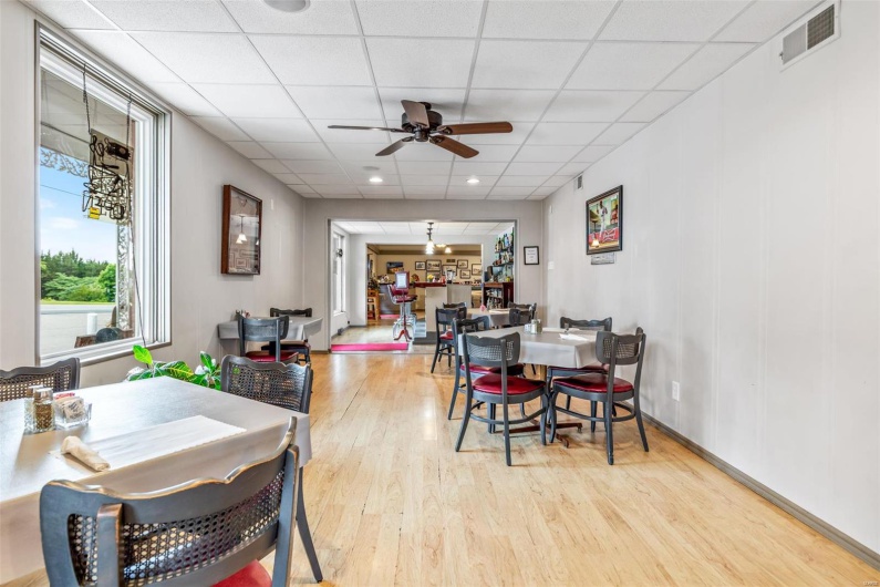 Dining room featuring a paneled ceiling, ceiling fan, and light wood-type flooring
