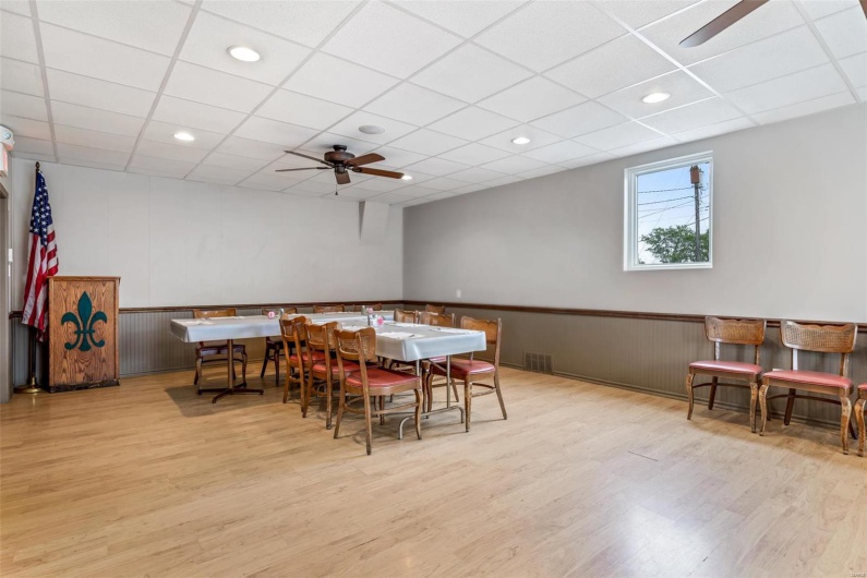 Dining area featuring a paneled ceiling, light wood-type flooring, and ceiling fan