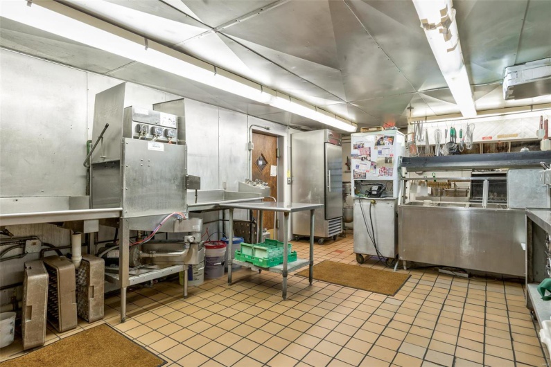 Kitchen with stainless steel counters and light tile patterned floors