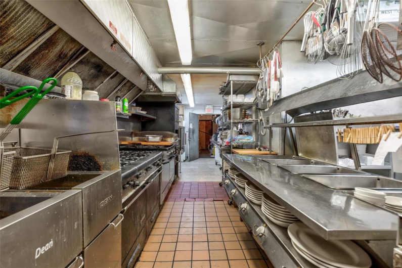 Kitchen with tile patterned floors and dark brown cabinetry
