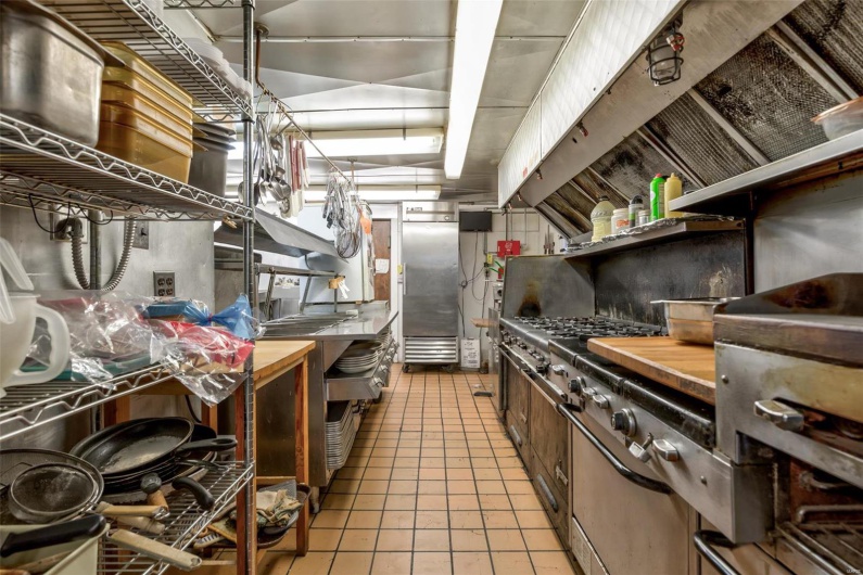 Kitchen featuring butcher block countertops and light tile patterned floors