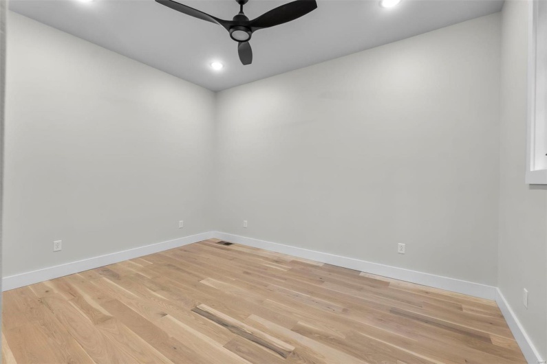 Unfurnished room featuring ceiling fan and wood-type flooring