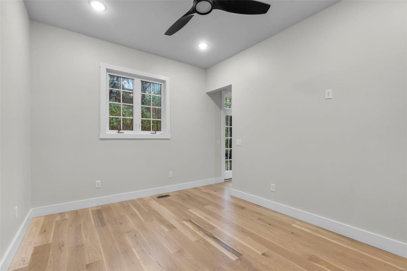 Unfurnished room featuring light wood-type flooring and ceiling fan