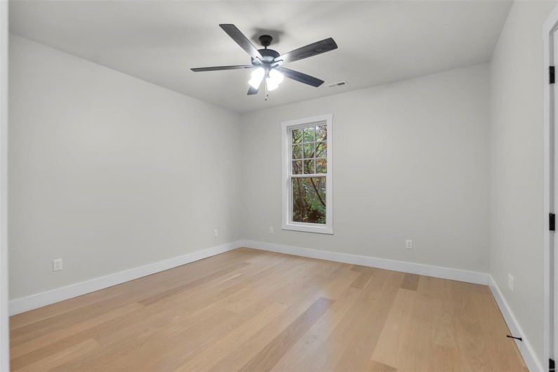 Empty room featuring light hardwood / wood-style flooring and ceiling fan