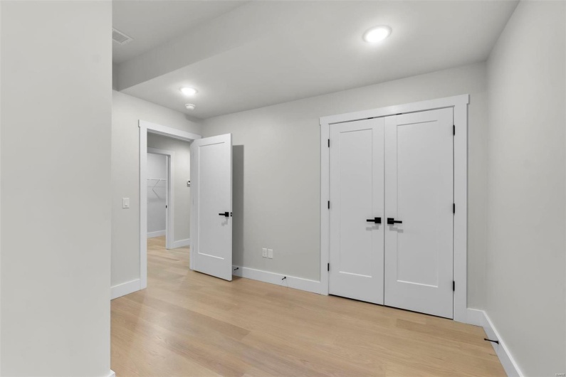 Unfurnished bedroom featuring light hardwood / wood-style flooring and a closet