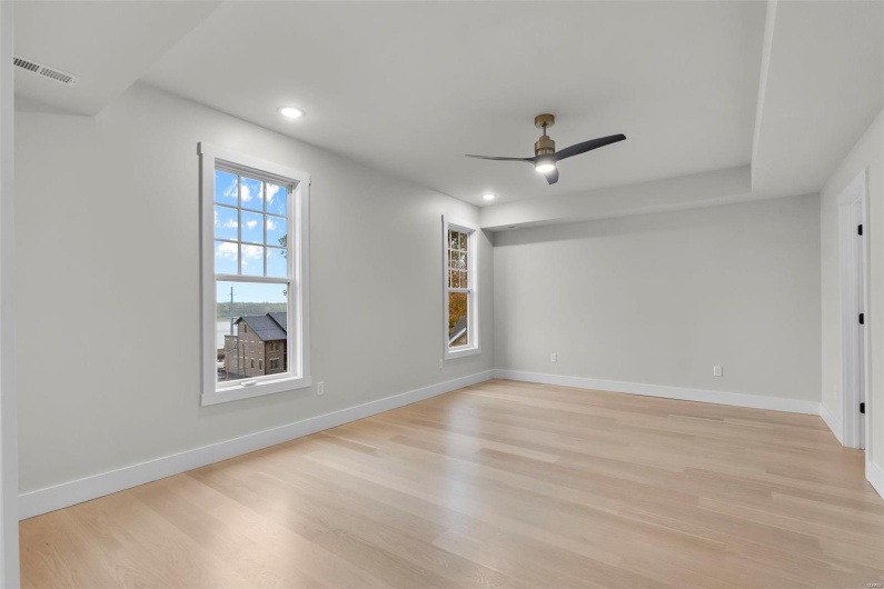 Spare room featuring ceiling fan and light hardwood / wood-style flooring