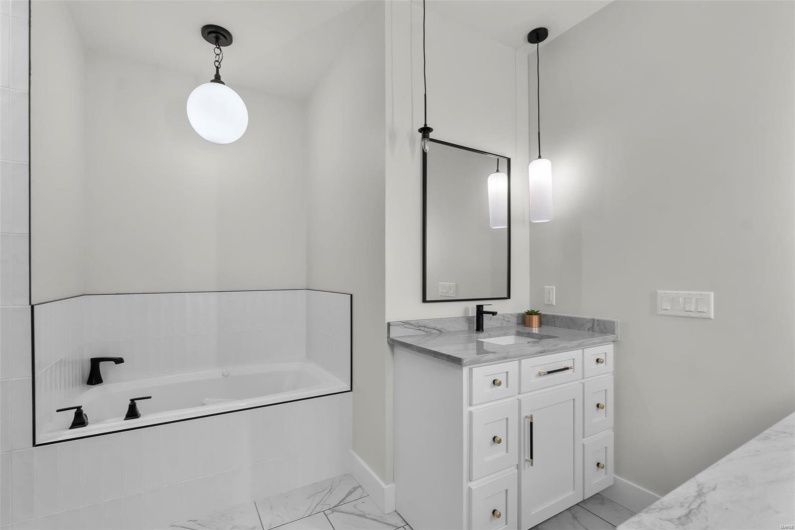 Bathroom with vanity and a bathing tub