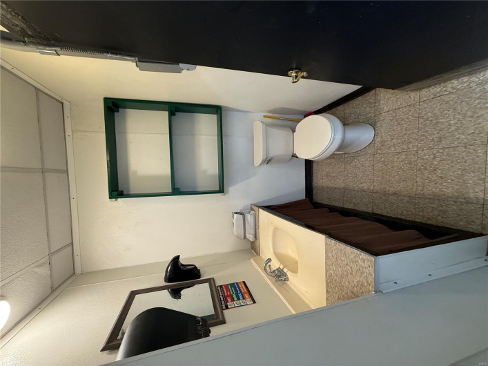 Half bathroom with vanity, a paneled ceiling, baseboards, and toilet