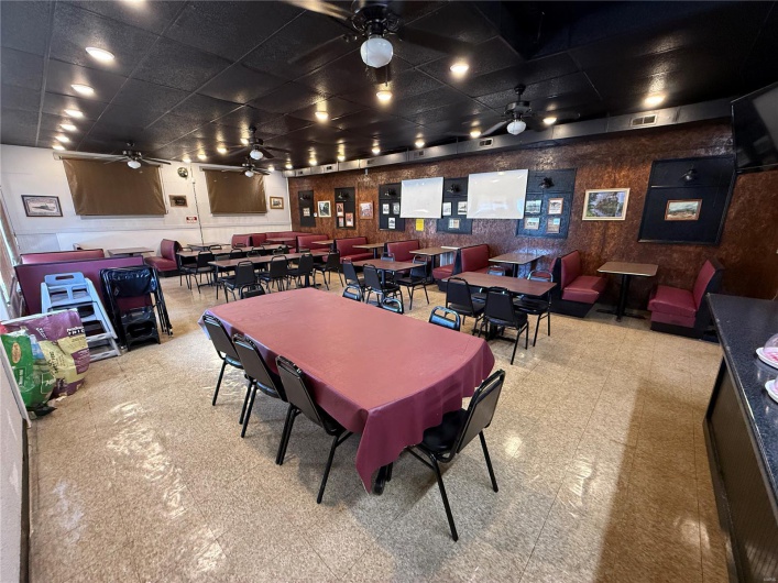 Dining room featuring a drop ceiling, tile patterned floors, a ceiling fan, and visible vents