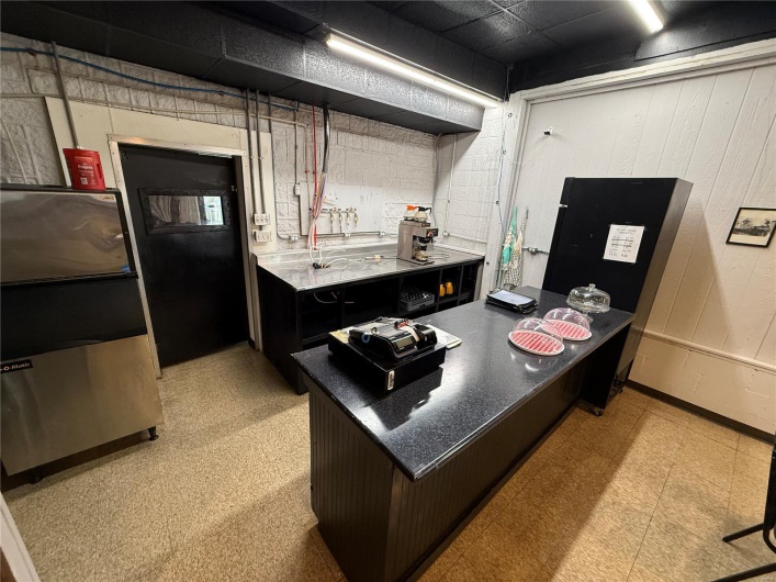 Kitchen with dark countertops and light floors